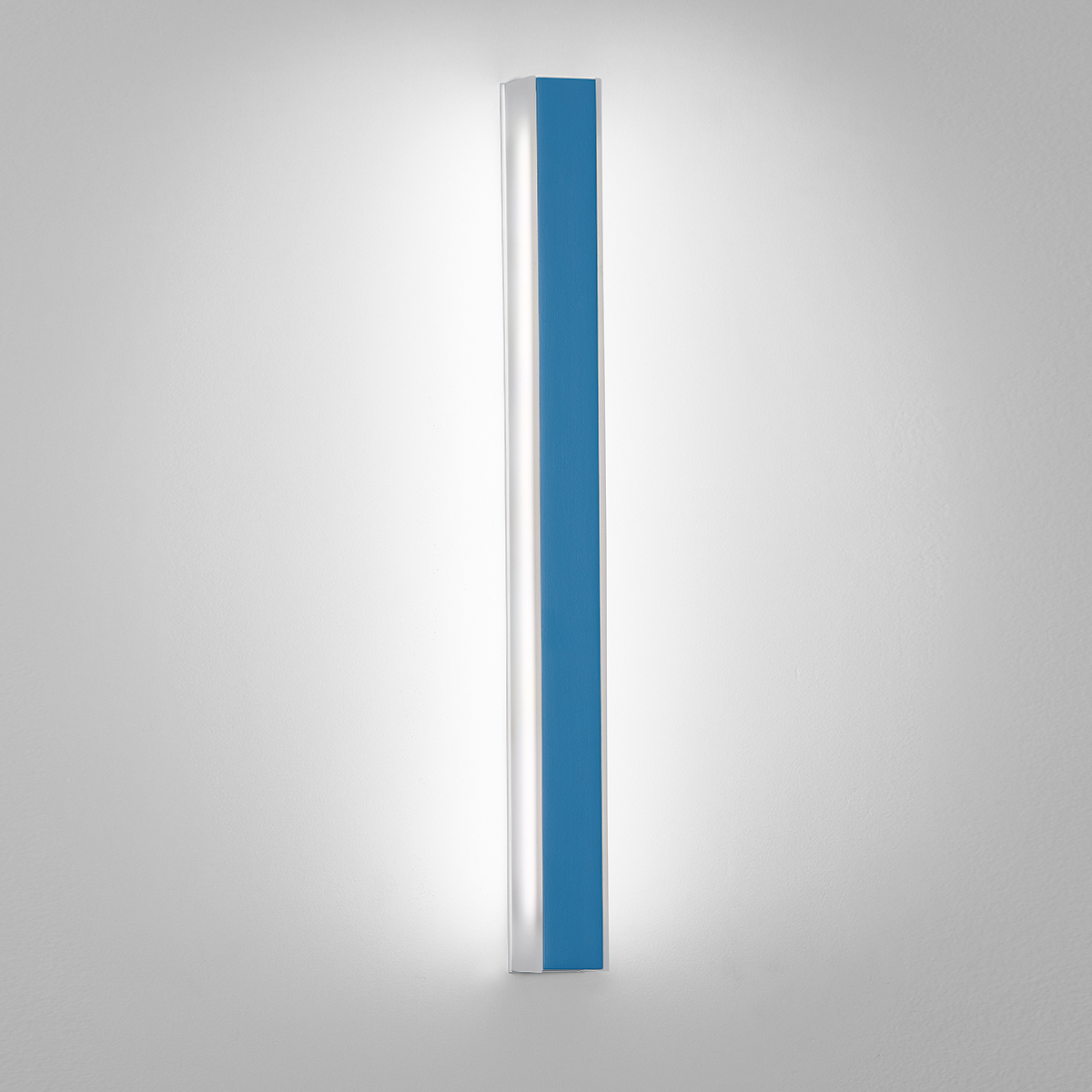 A thin, surface mounted luminaire with a linear body and soft side lighting