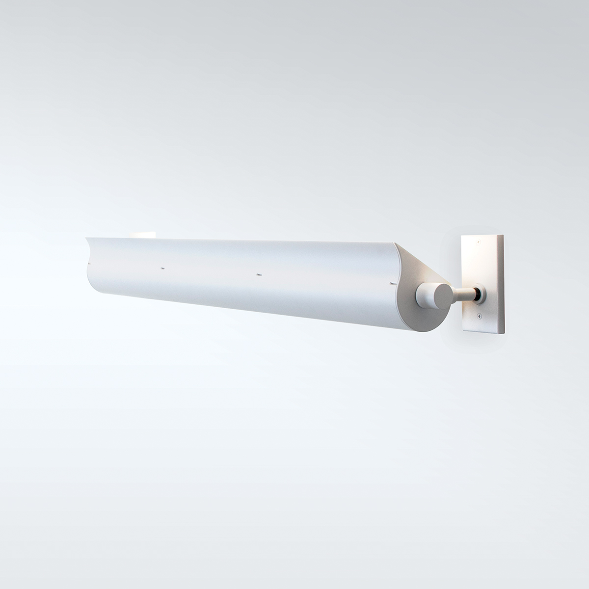 A wall-mounted linear indirect luminaire with mounting brackets on each end