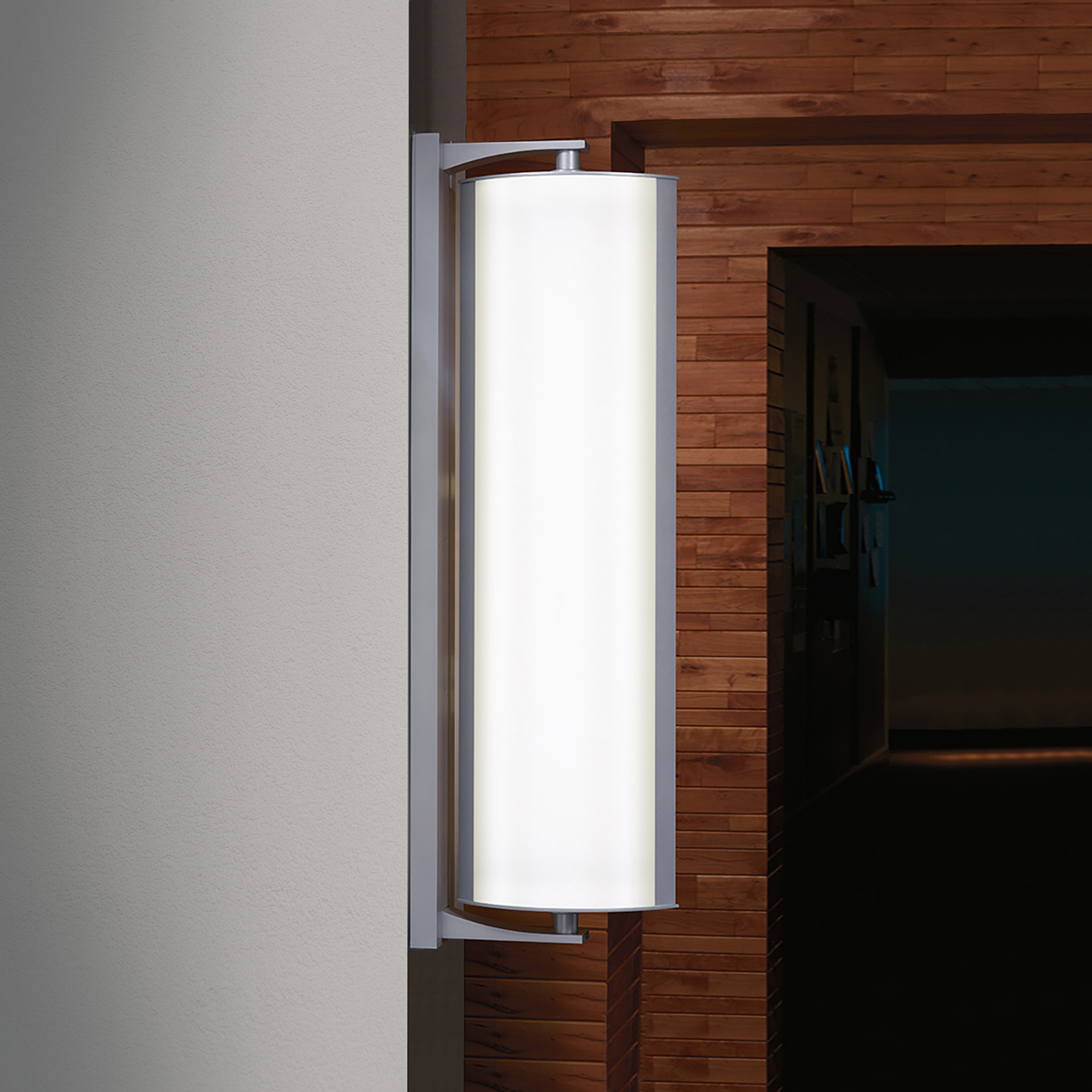 A large, rectangular luminaire that mounts closely to the wall with a top and bottom bracket