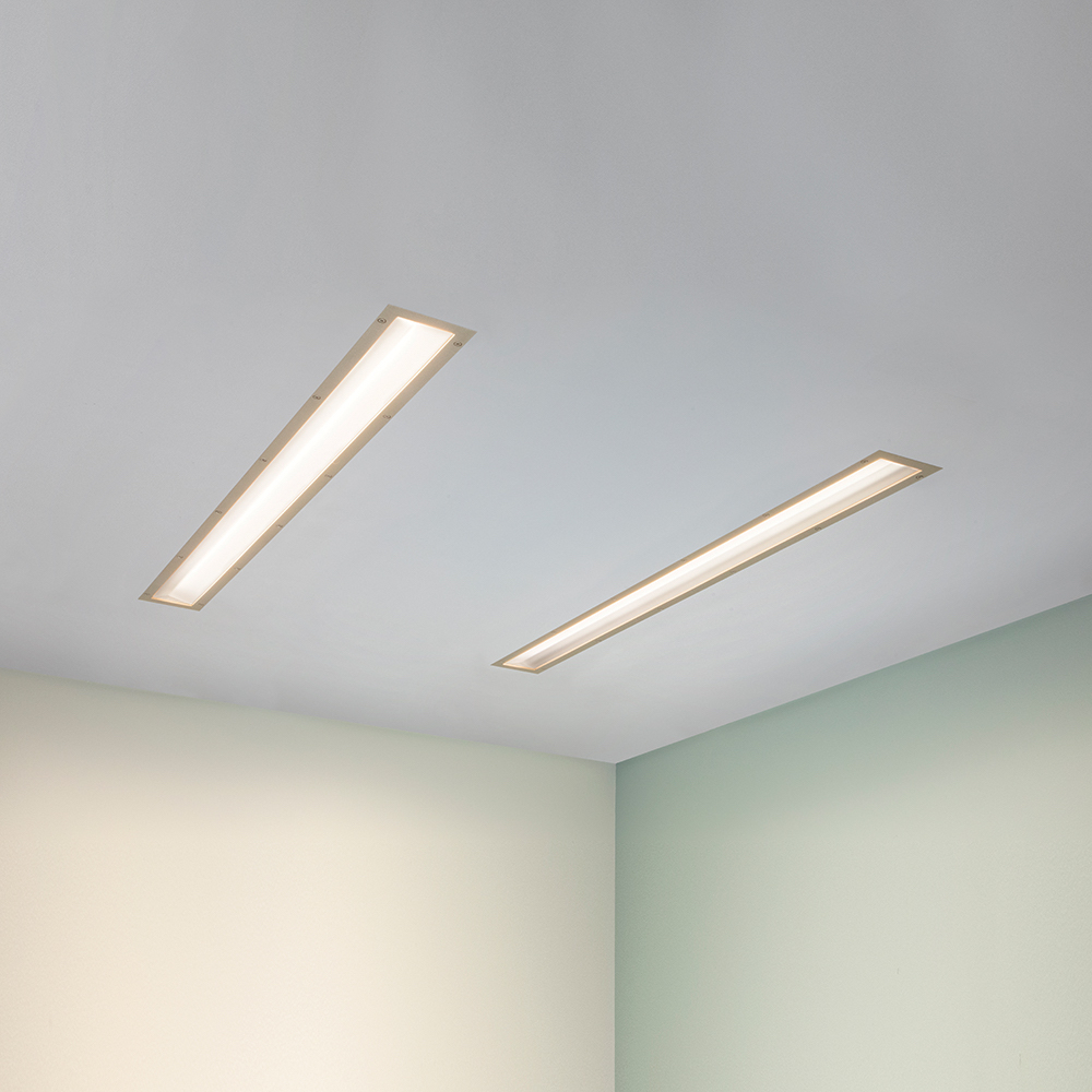 A thin dual unity overbed luminaire for patient lighting