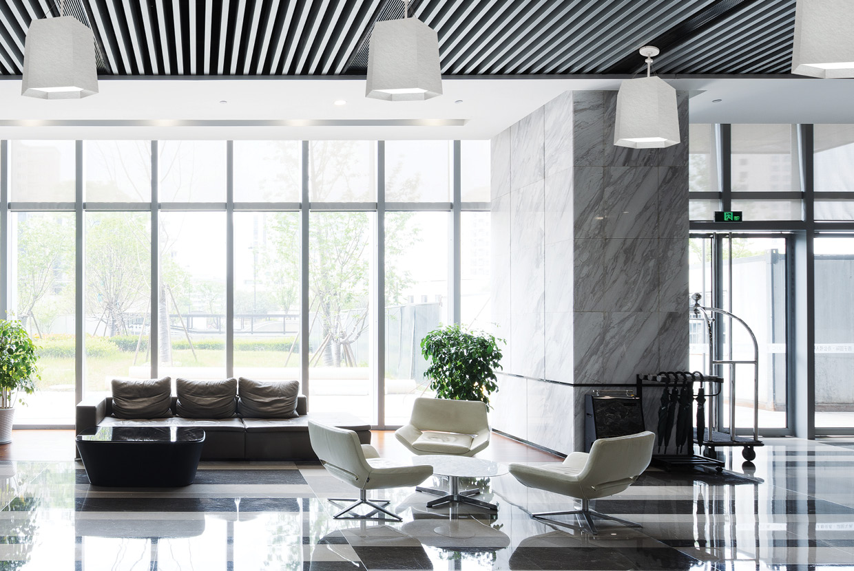 White acoustic felt on large venue light hung in hotel lobby. 