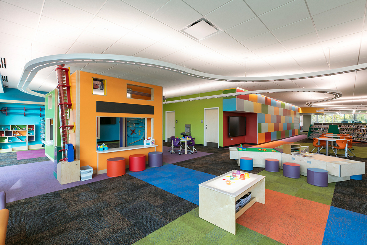 Infinity Performance configurable pendant in education lighting design above modern children's library. 