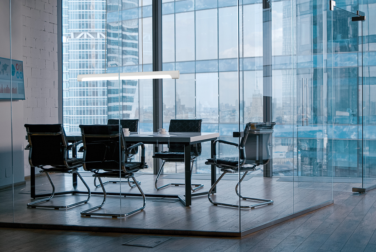 Nacelle pendant in an all glass conference room