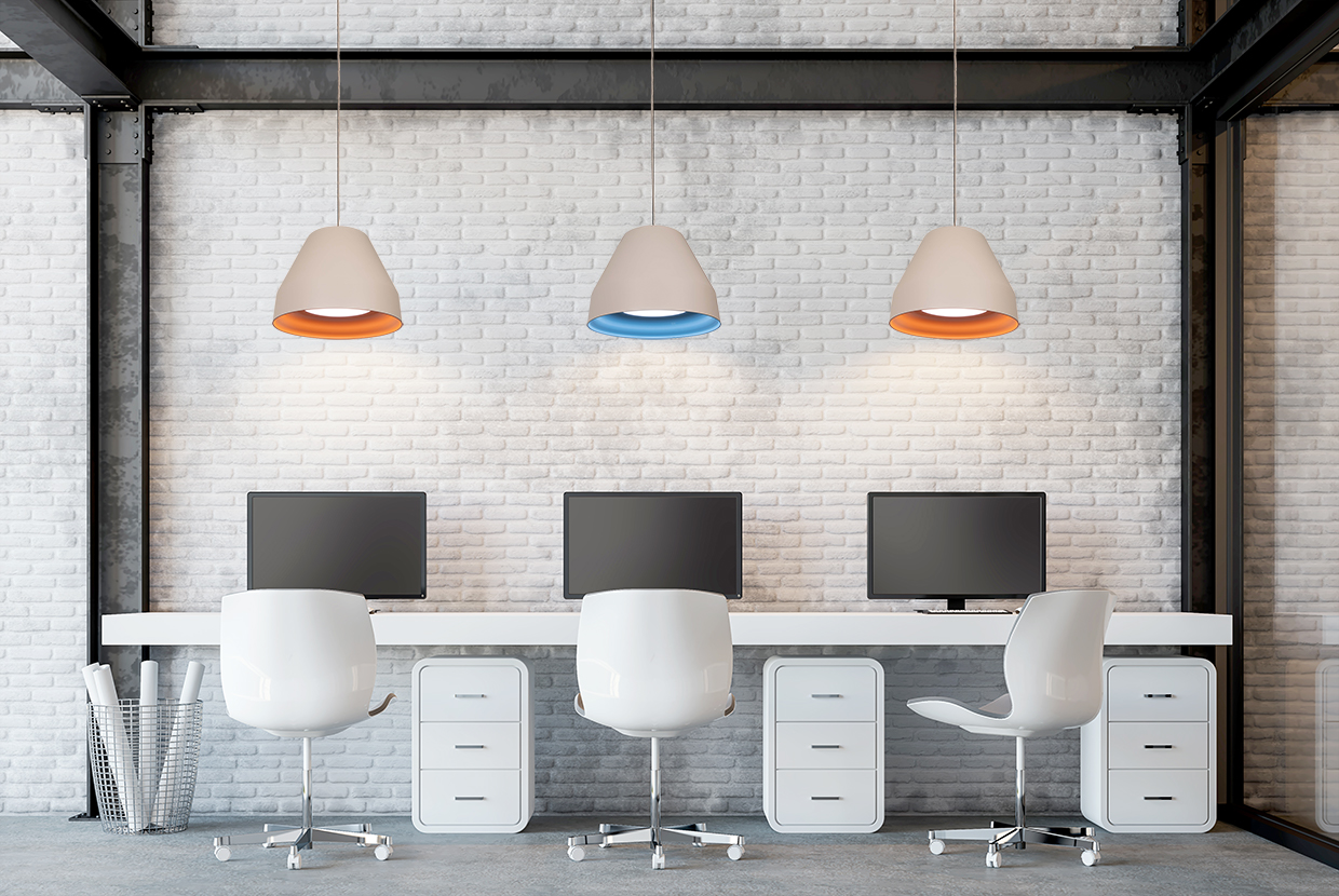 Modern bell pendant light hung over computer workstations for glare free lighting.