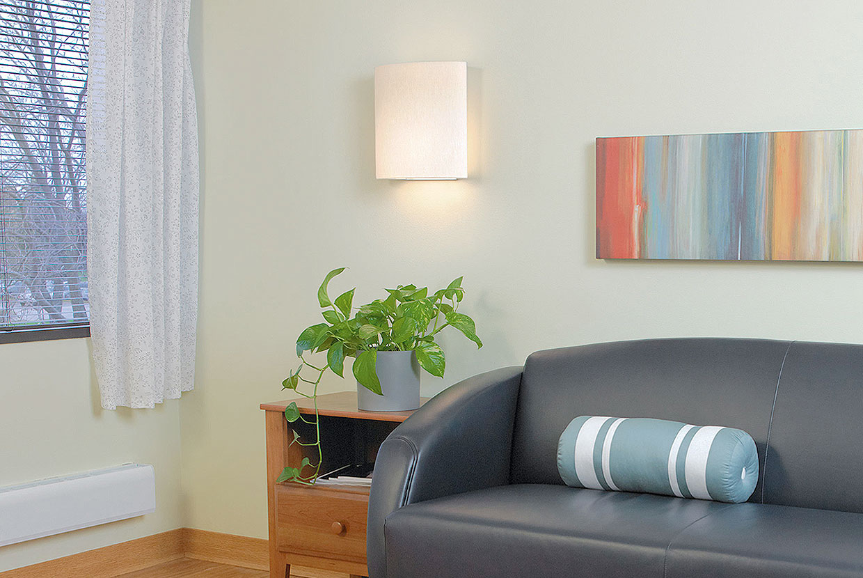 Unity Sconce Healthcare Lighting Above Couch and Plant