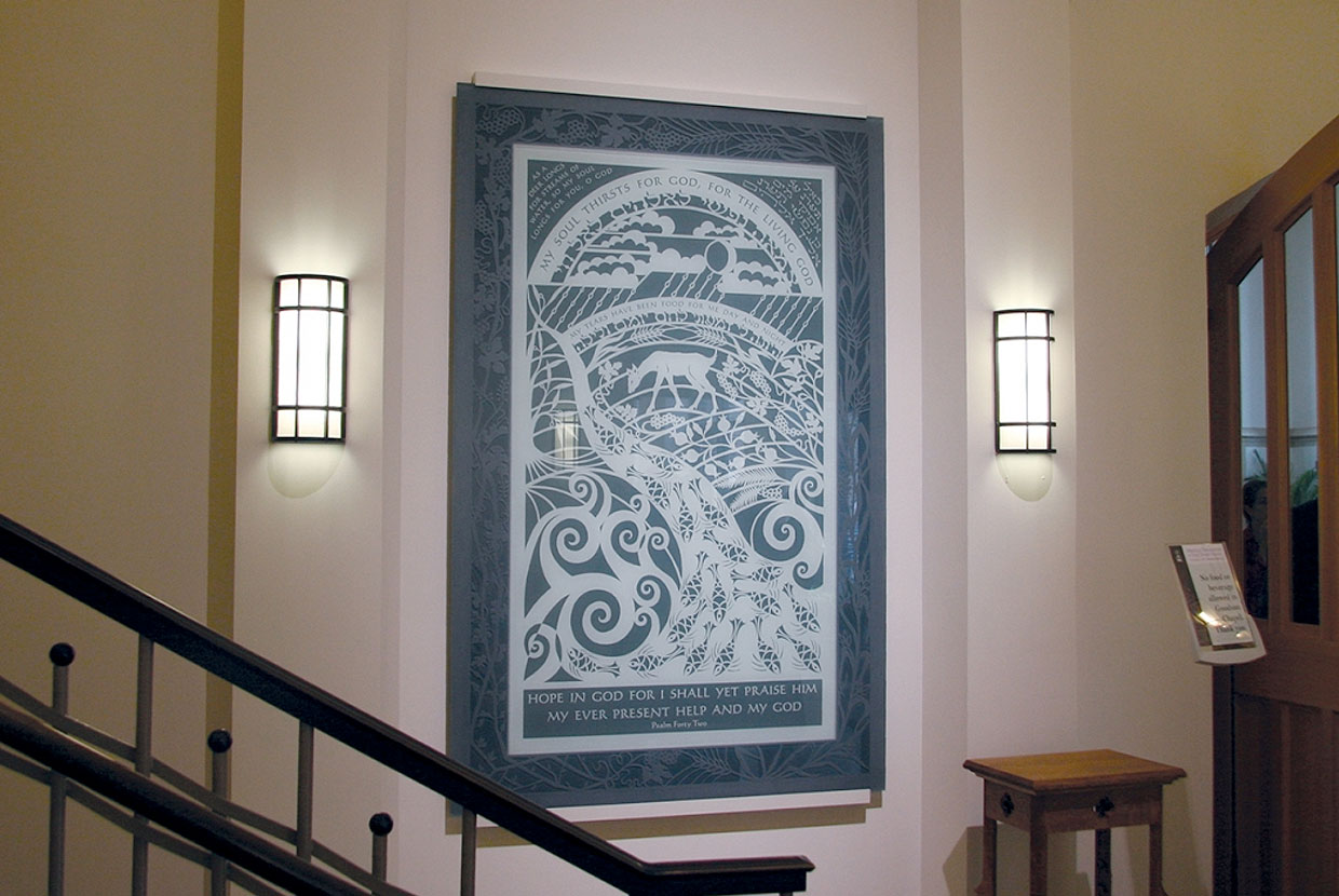 Colonnade wall sconces in an education lighting application alongside campus hallway artwork. 
