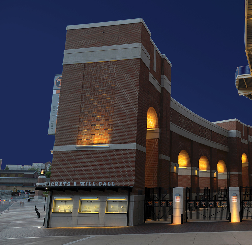 Advantus linear outdoor light fixtures illuminate a brick ticket area for a college stadium at night.