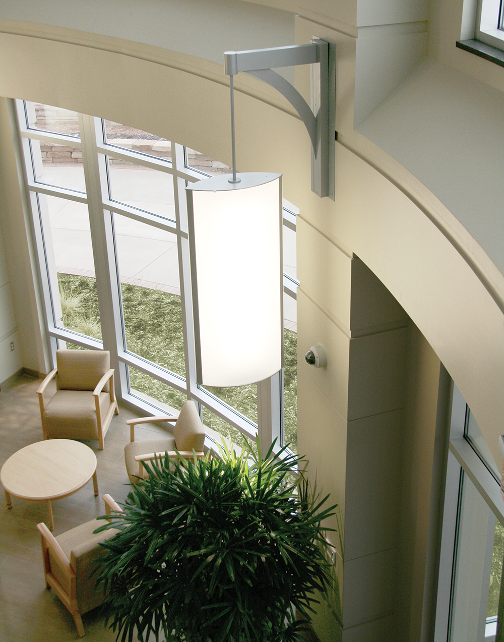 Air Foil custom light fixtures hung as a sconce pendant with a metal arm and stem.