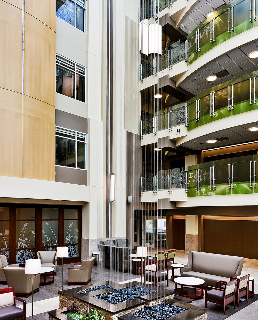 Air Foil large venue fixtures float above a healthcare design lobby to light up multiple floors.