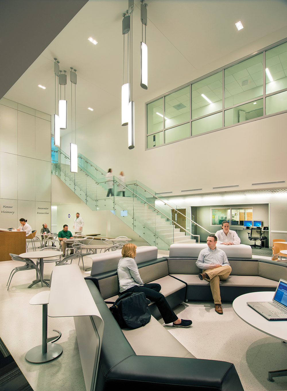 Air Foil pendants illuminate a large waiting room for a modern hospital lighting application.