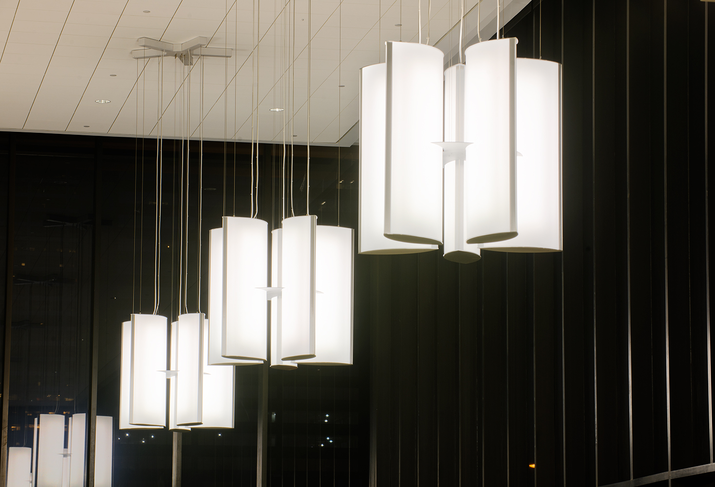 Air Foil pendants in a lobby lighting configuration, each cluster a group of five elliptical panels.