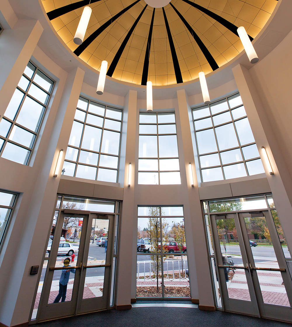 Asta wall sconces and Sequence tube pendants provide clean, modern lighting in a linear form for this library entryway.