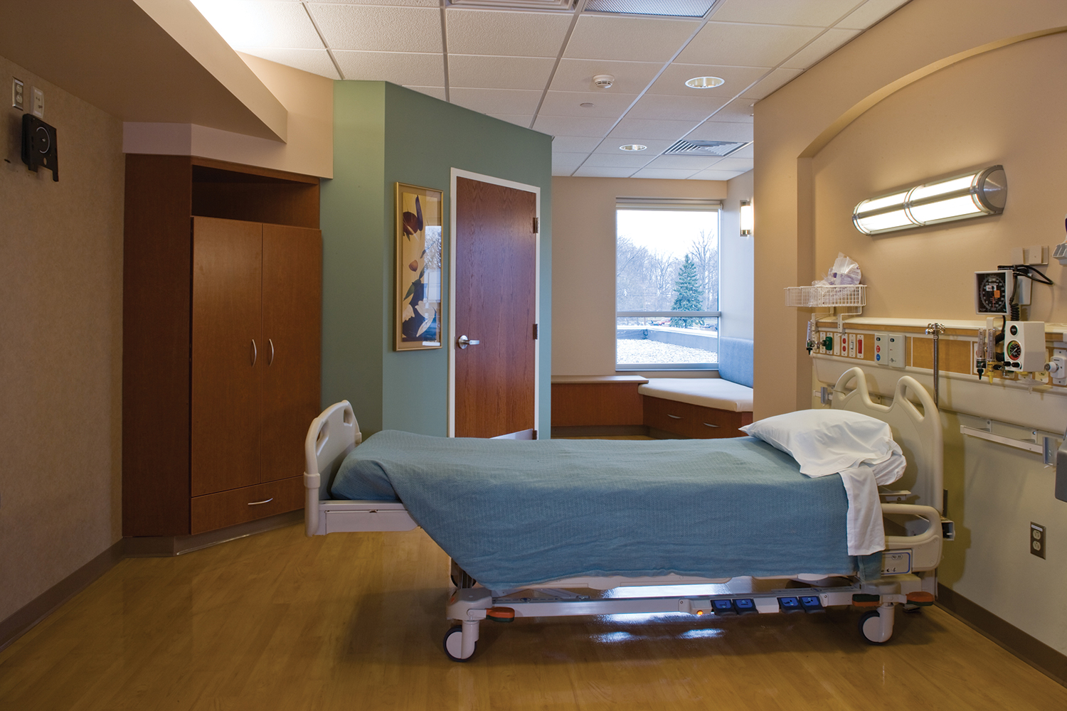 Avatar wall mounted fixture as a headwall in a patient room for sophisticated hospital lighting design.