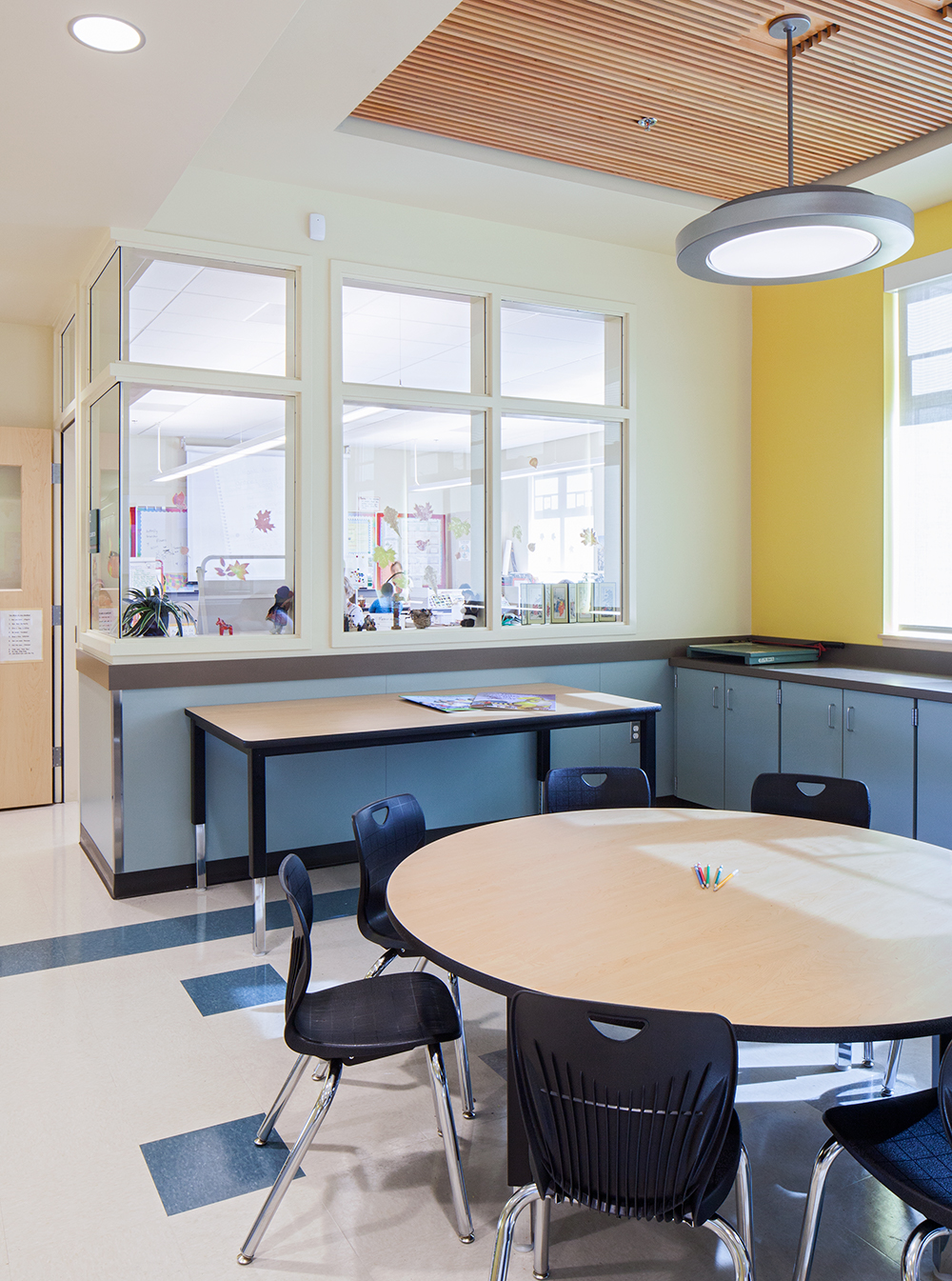 Broadway pendants in an education lighting design, seen here above a classroom table.