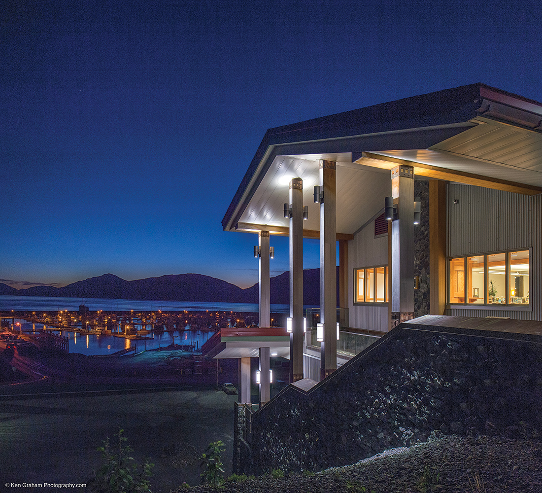 Colonnade and Scope exterior lighting fixtures illuminate a waterfront building with clean, modern light.