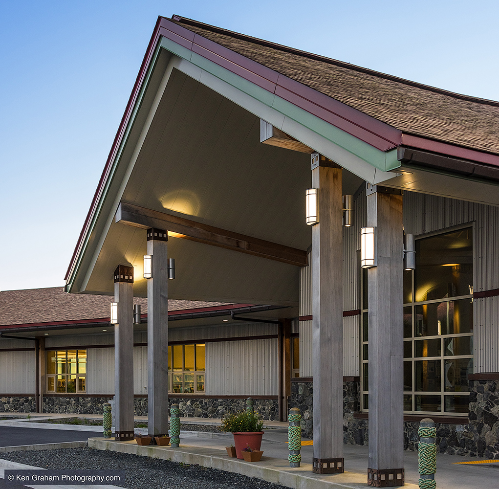 Colonnade and Pla exterior lighting fixtures on support beams above a sophisticated entryway.