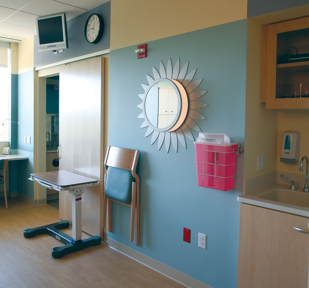 These custom light fixtures were tailored in a sunflower shape and center mirror to light up this children's hospital patient room.