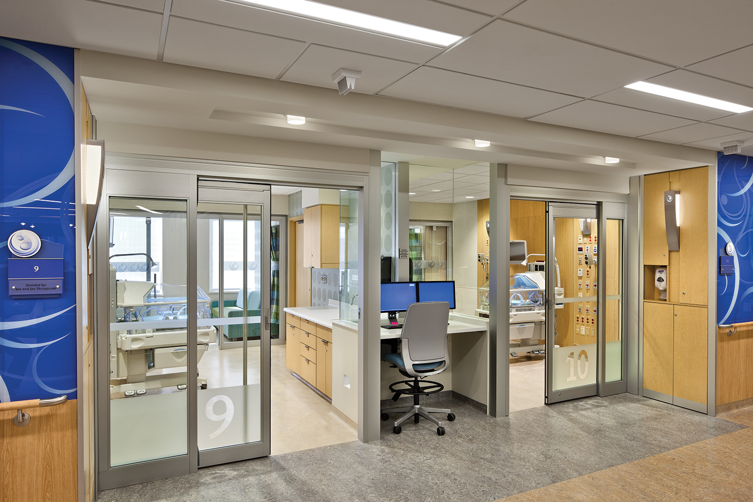 Cypress custom light fixture in a healthcare facility, with the facility logo cut out of the luminaire body.