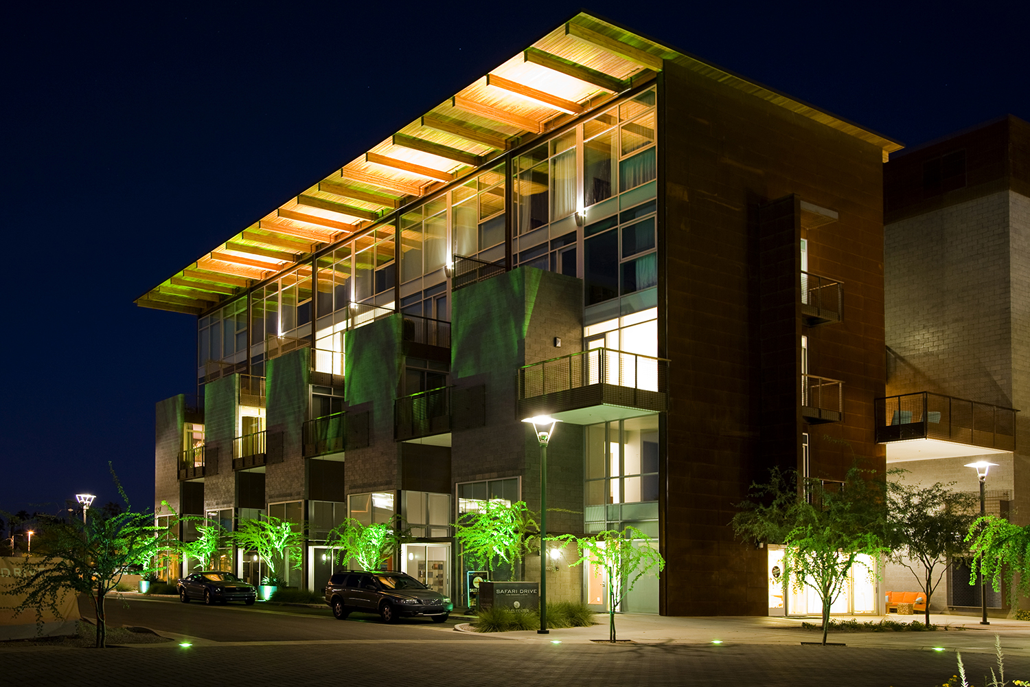 Cypress outdoor light fixtures provide soft uplight for the upper floor of a multifamily building