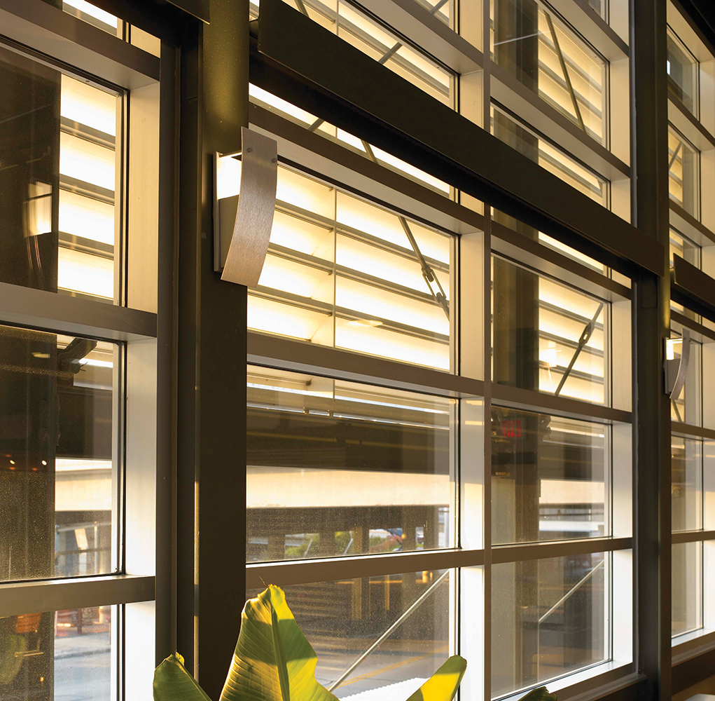 Cypress wall sconces work well for retail lighting applications, seen here between café windows