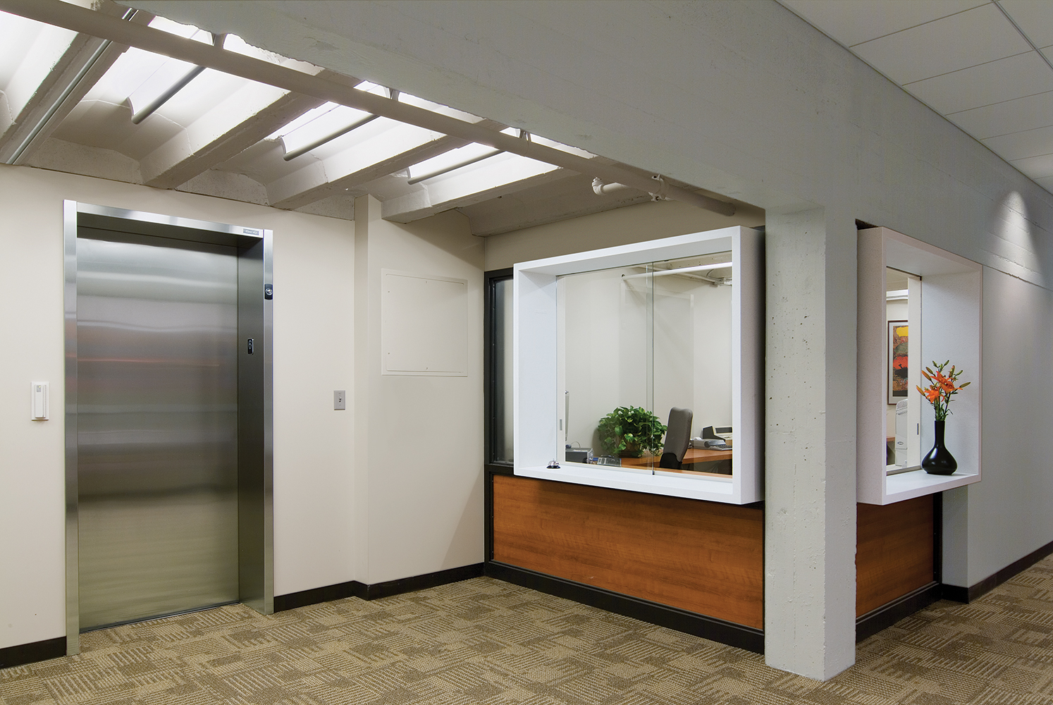 Ether ceiling-mounted luminaires in a medical lighting application above a clinic elevator