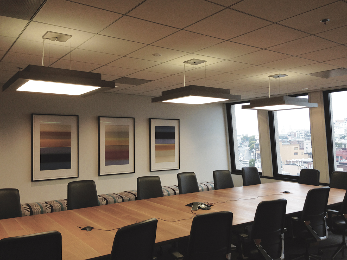 Fifth Avenue office lighting fixtures above a metropolitan workplace conference table