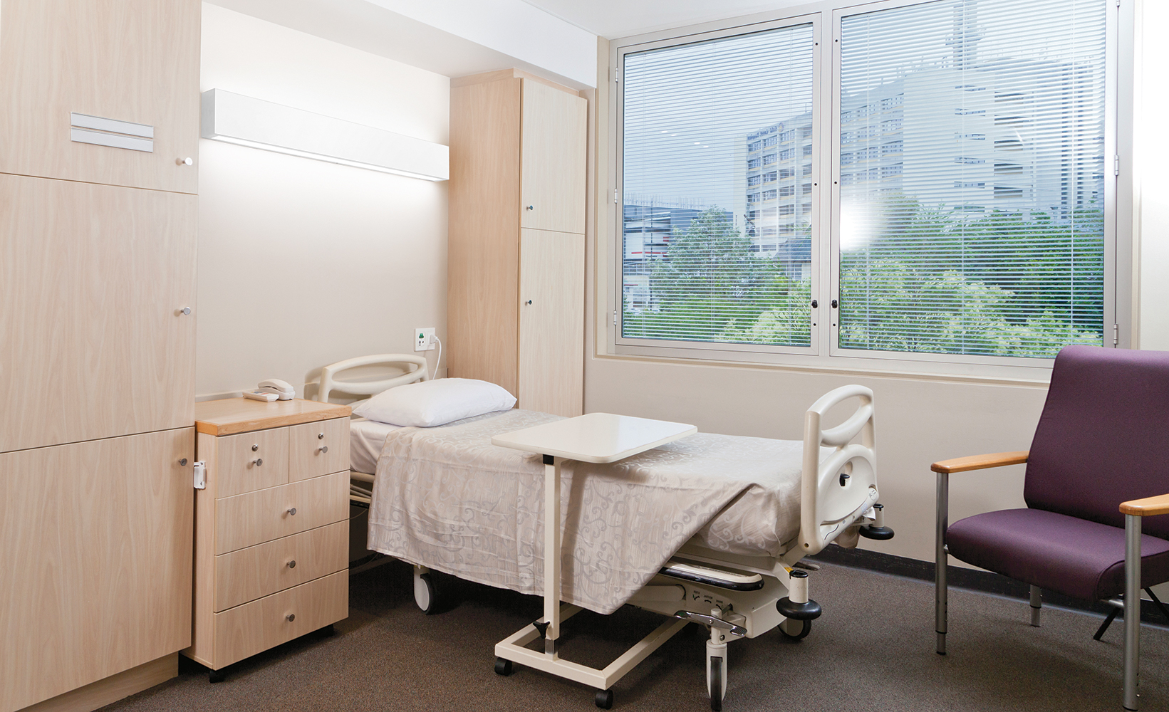 Linear Art Sconce as patient room lighting, mounted horizontally above the patient bed overlooking a large window.
