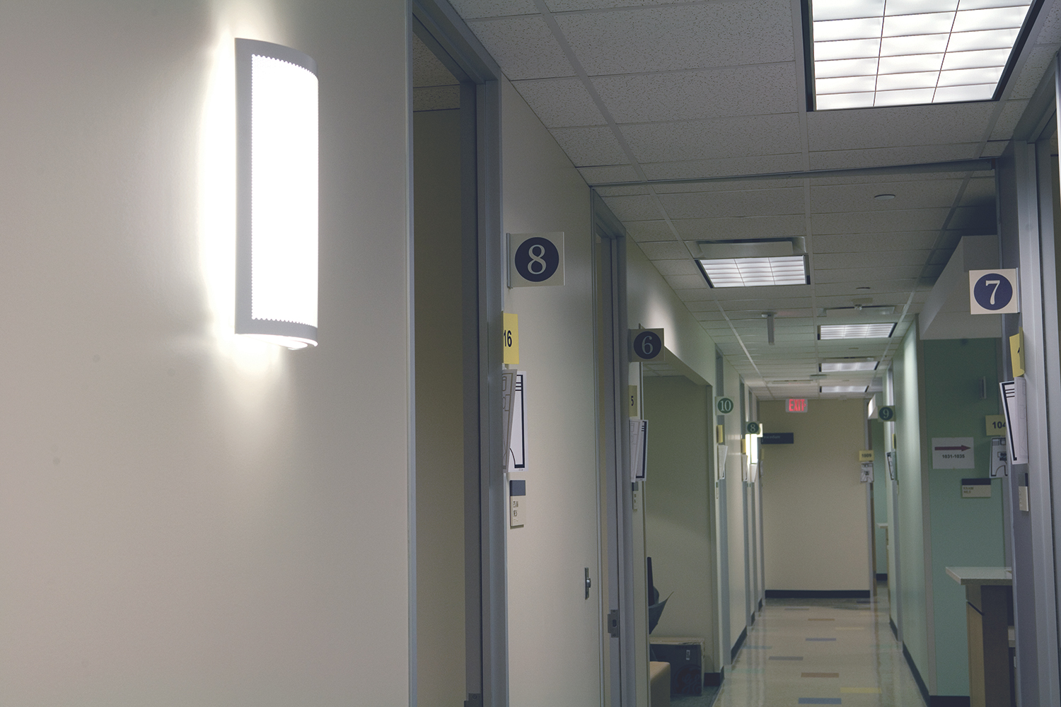Masque modern wall sconce in a medical lighting application along a hospital corridor.