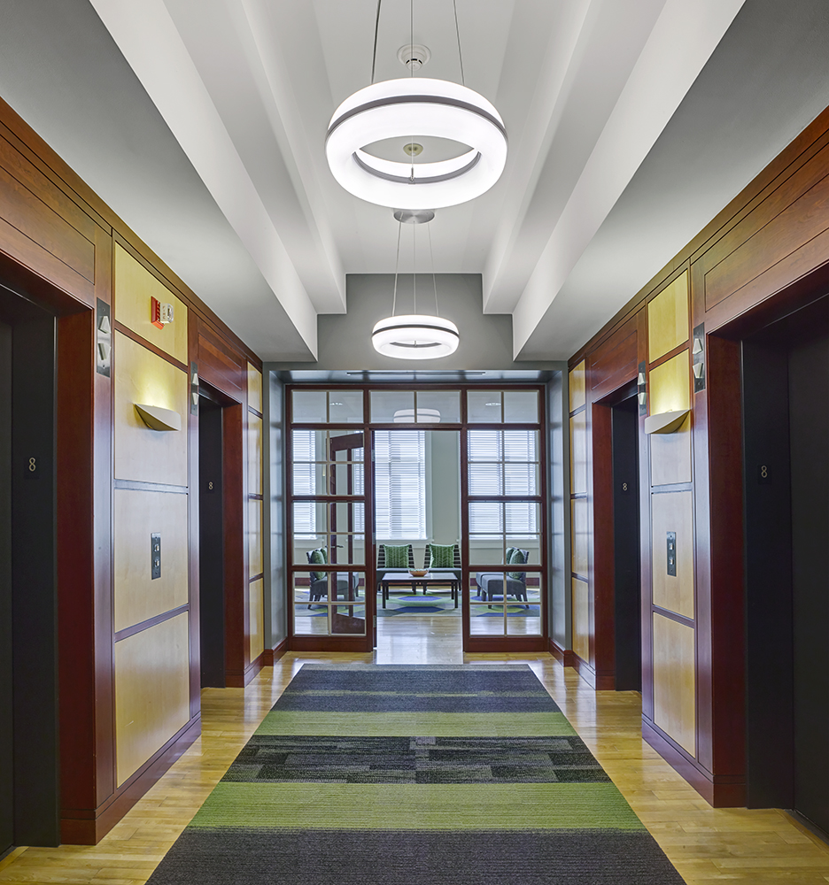 Meridian Round pendant is perfect for office lighting, seen here above a corridor in a modern design office.