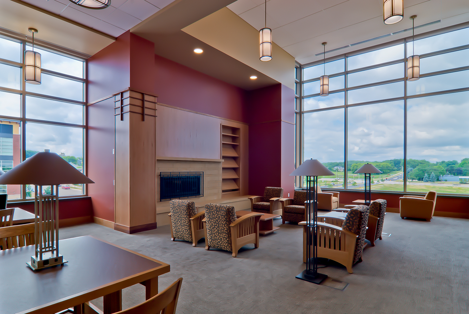 Midland Arts custom pendants and South Bay portable table lamps in a library lighting design illuminating the library's modern entryway.