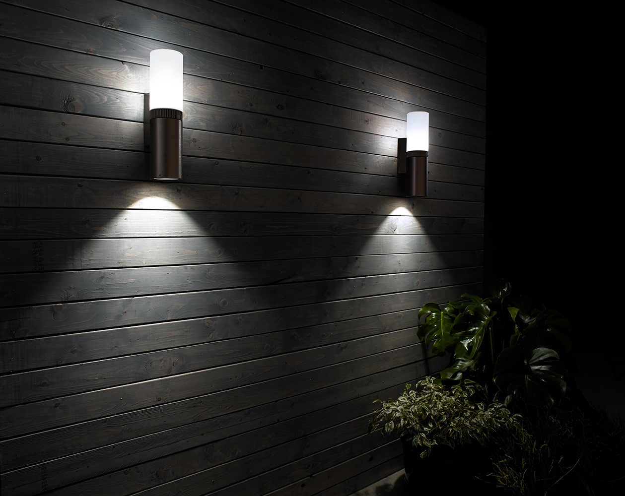 Scope exterior luminaires illuminate an outdoor apartment lighting design with soft diffused light and attractive downlight.