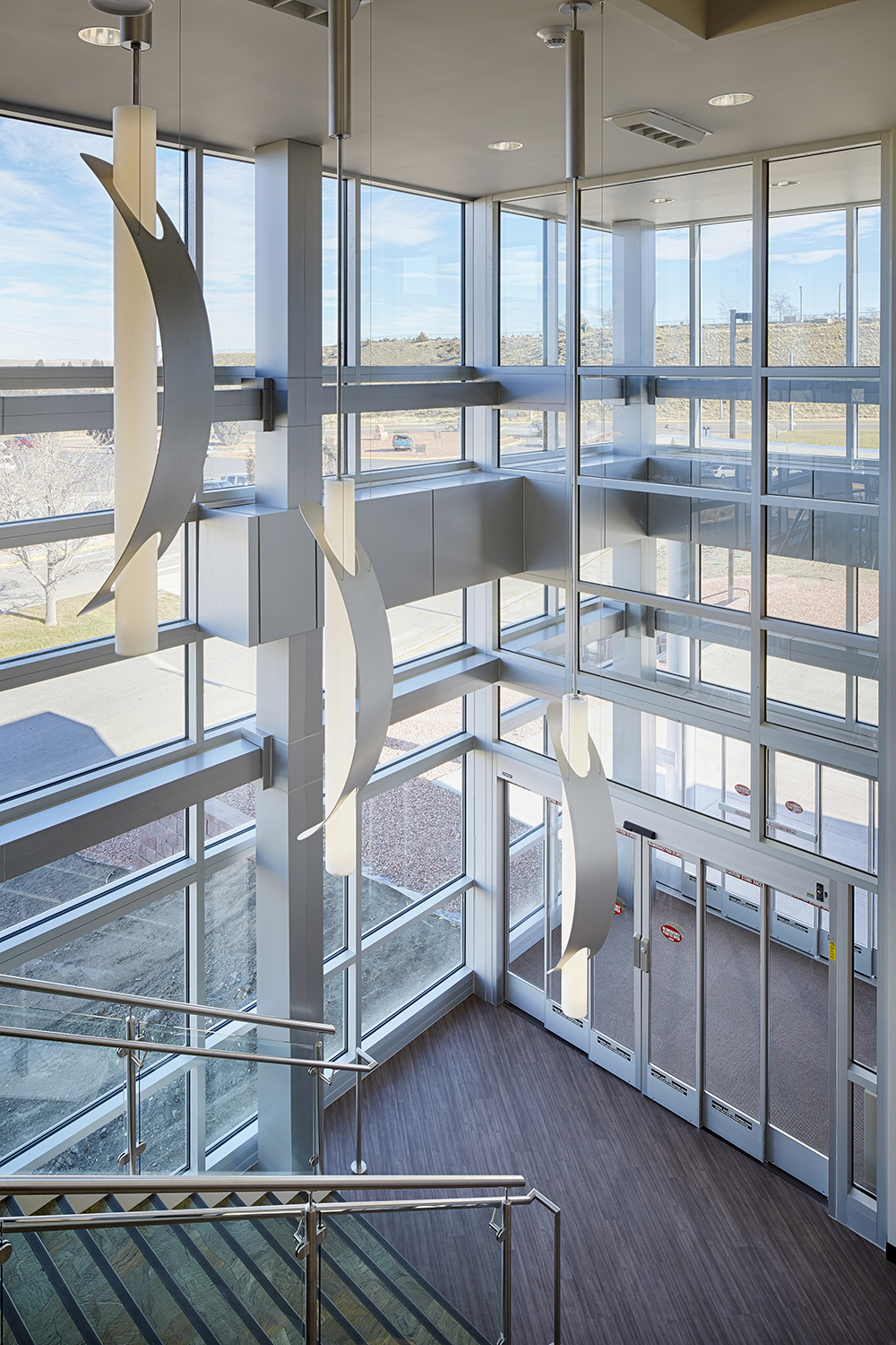 Sequence pendants enhance educational interior design in a well-lit exposed staircase.