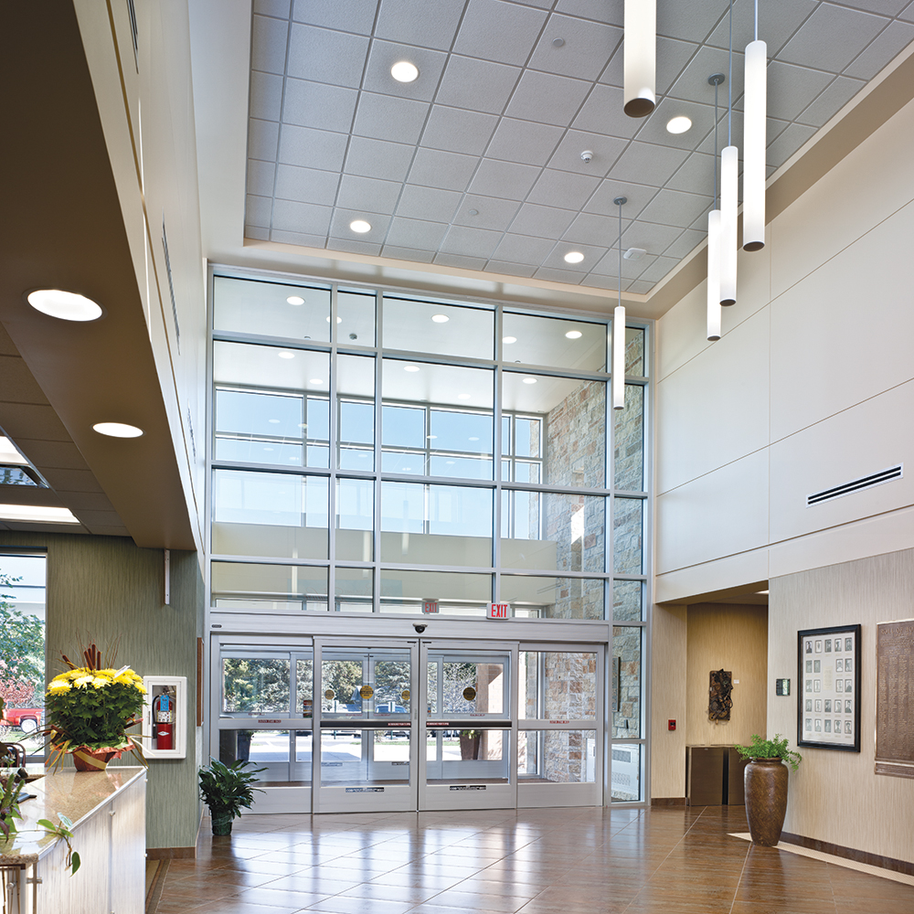 Sequence pendants feature in a large clinic lobby for airy healthcare design.