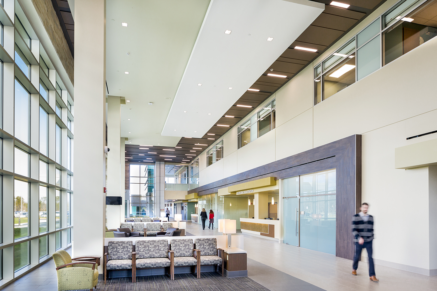 Serenity table lamps provide comforting healthcare design in a large waiting area and hospital corridor.