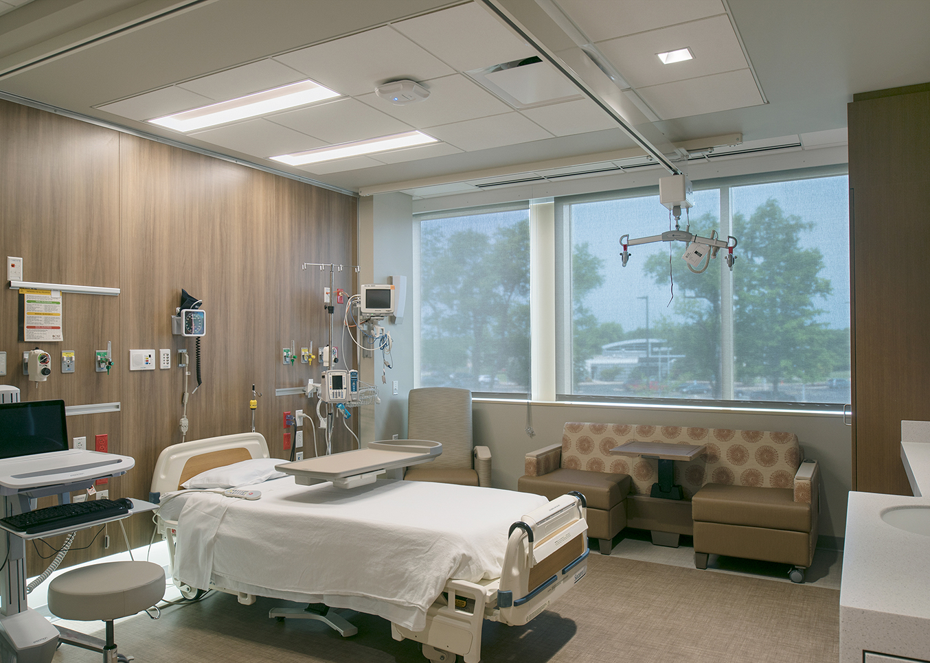 Serenity tandem overbed lighting in a soothing, nature-inspired patient room.