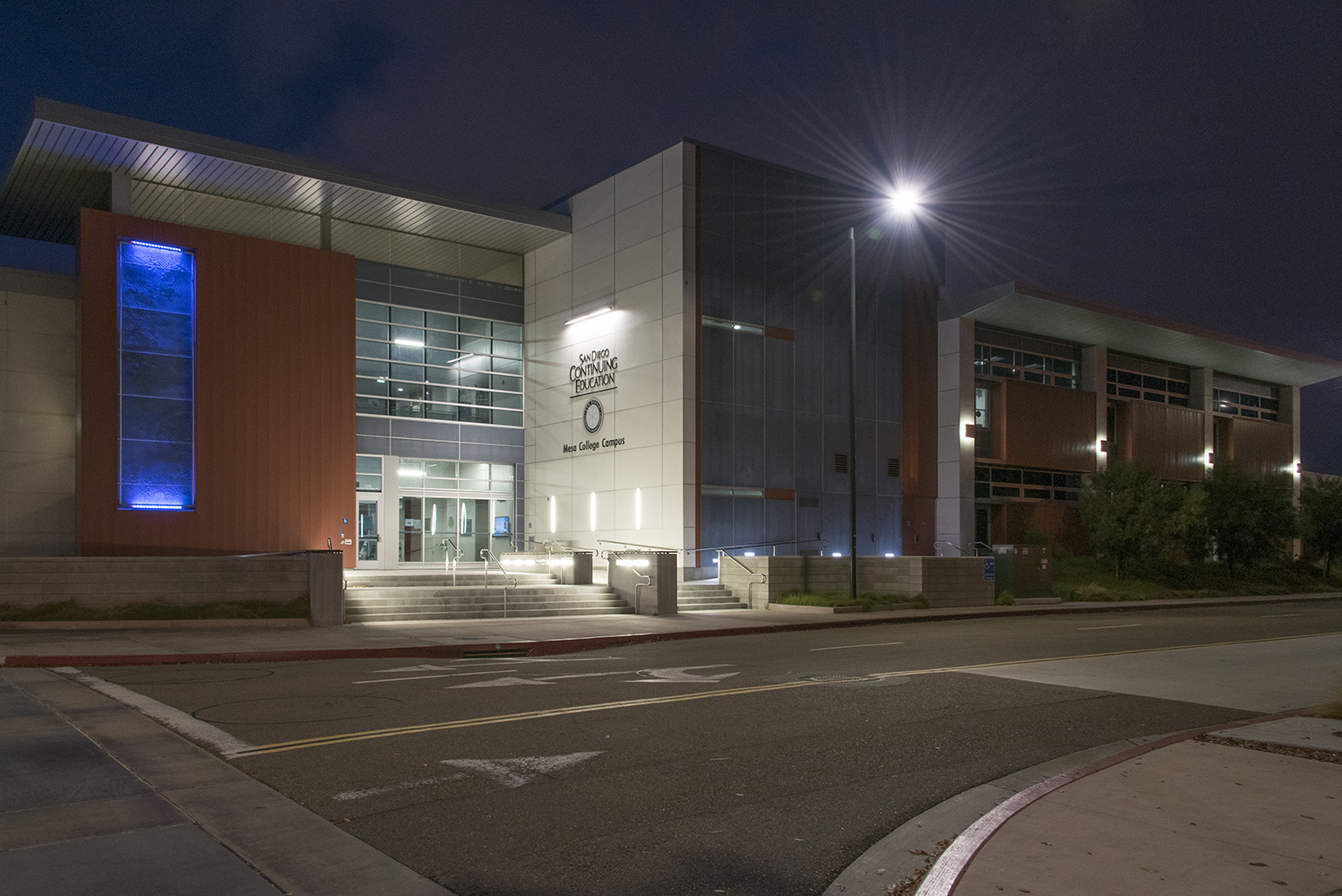 Southridge outdoor light illuminating a campus building at night.