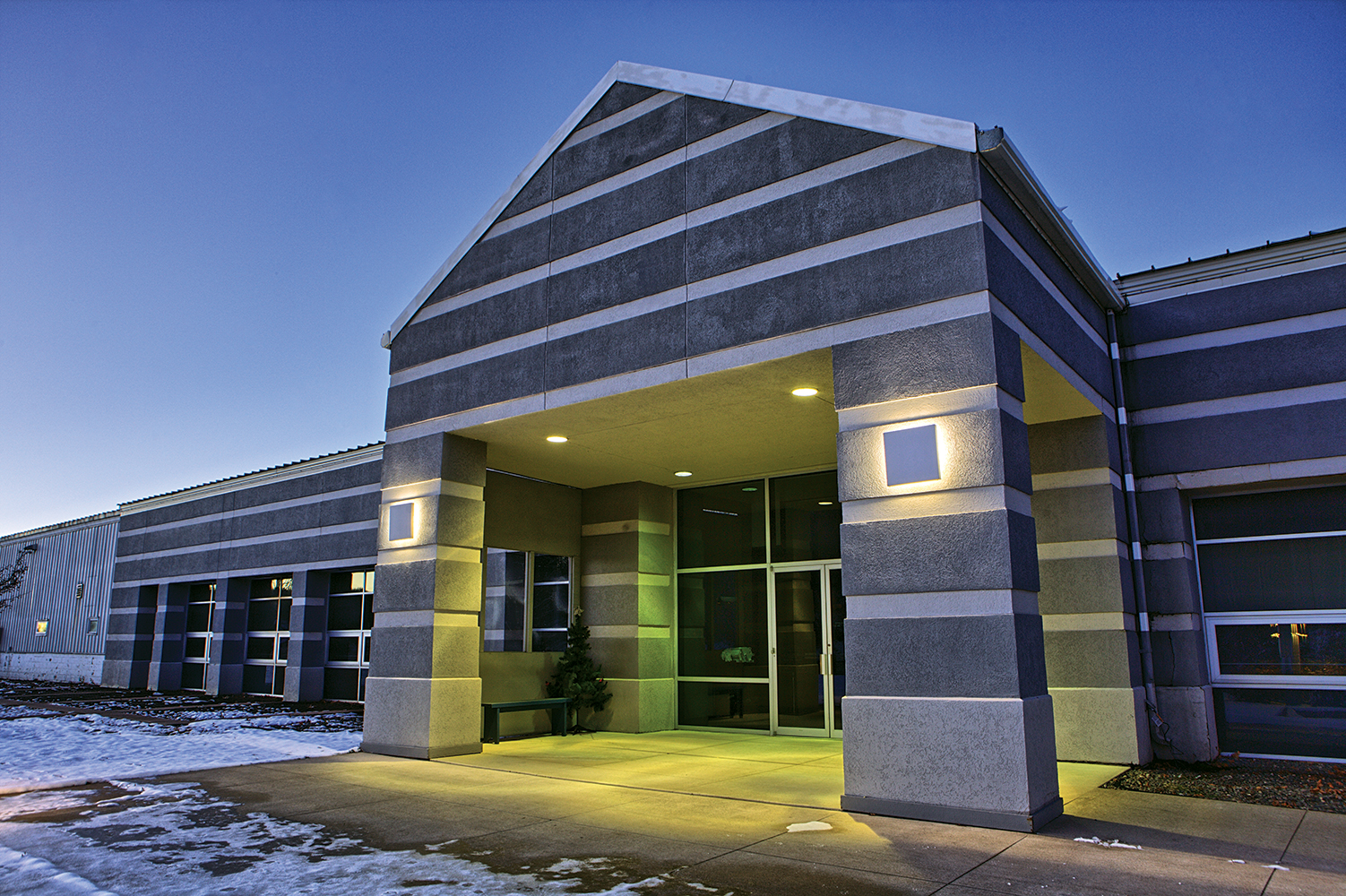 Southridge outdoor light fixture illuminating an office building entryway.