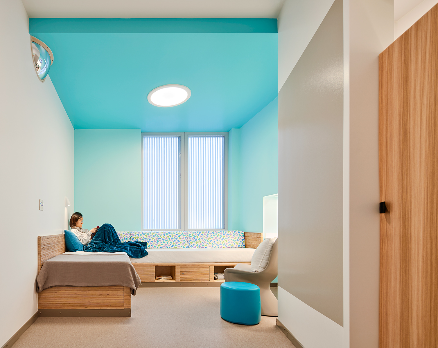 The Symmetry ceiling light and Gig sconce in a behavioral health patient room