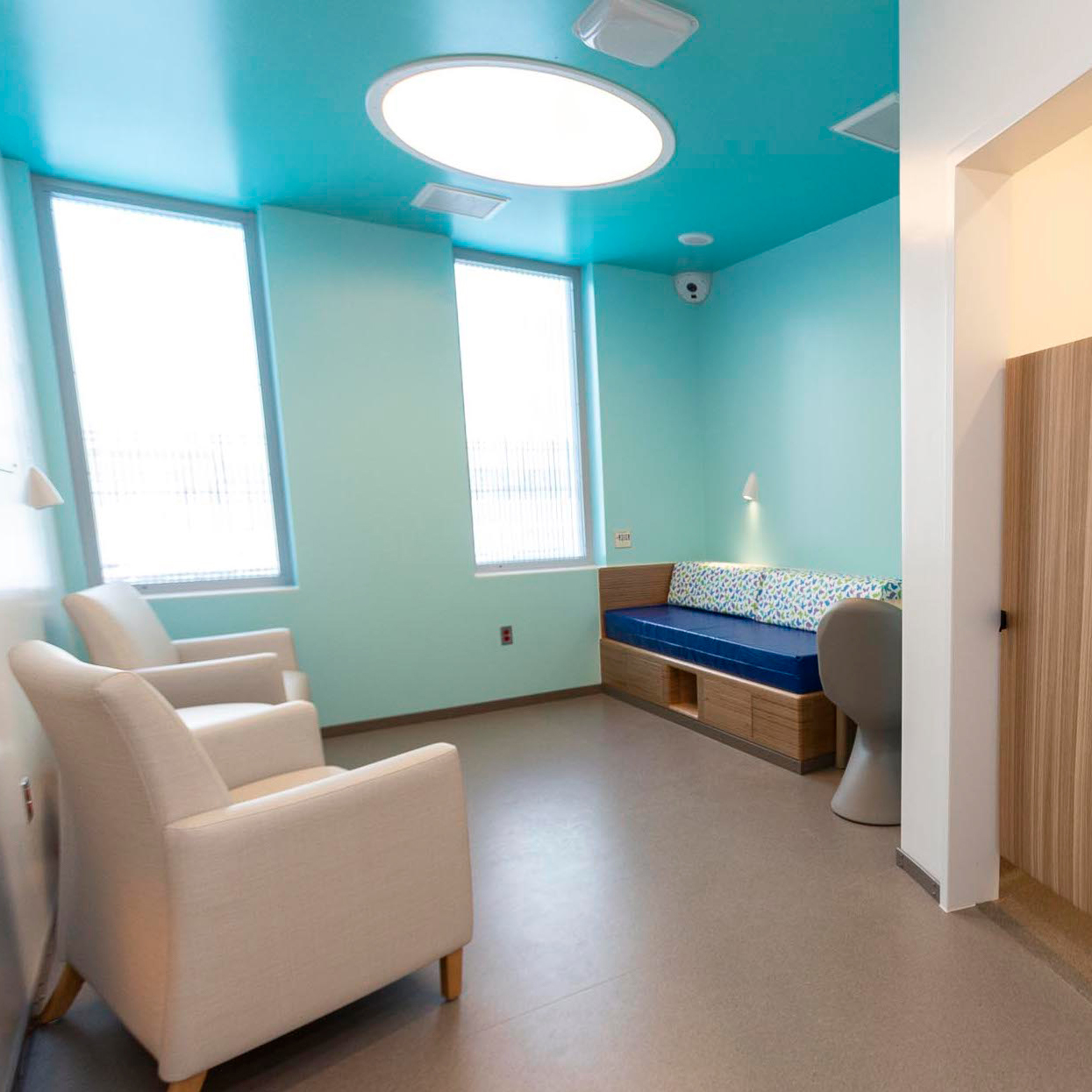 The Symmetry ceiling light and Gig task light in a behavioral health patient room