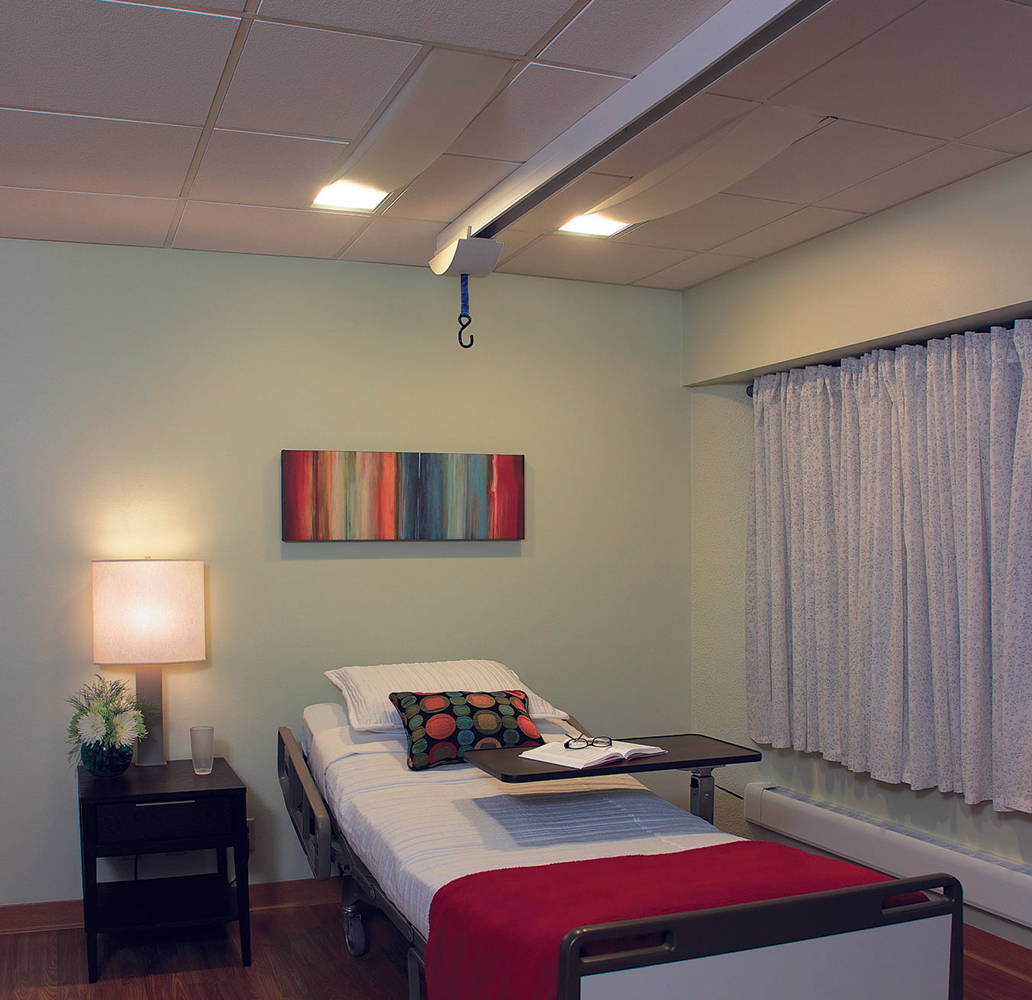 Unity medical lighting in table lamp and overbed luminaires in exam mode over a patient bed.