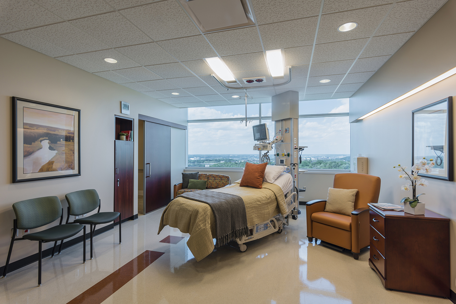 Unity patient room lighting over a patient bed in front of a wide window.