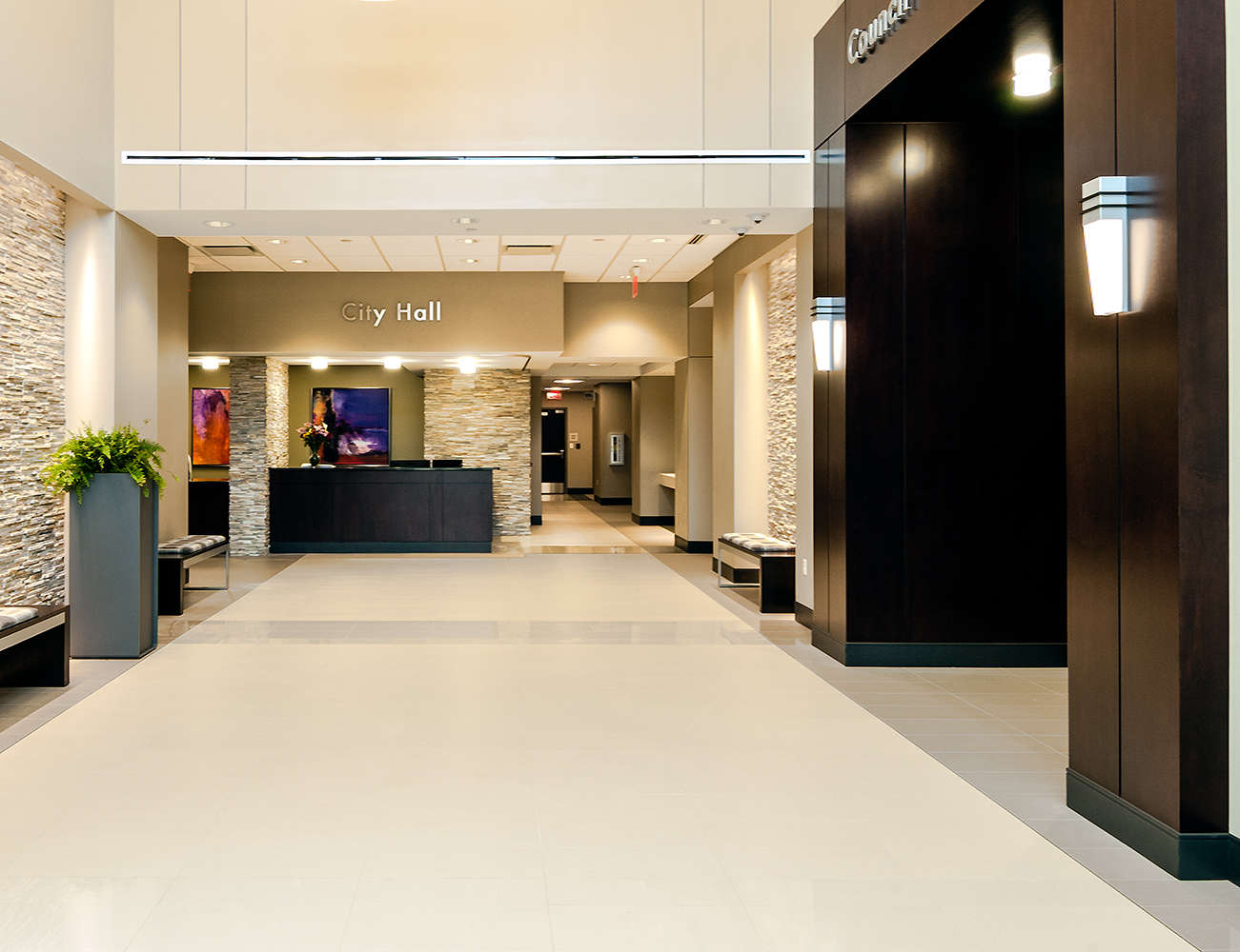 Wedge architectural lighting sconces illuminate a municipal center lobby  