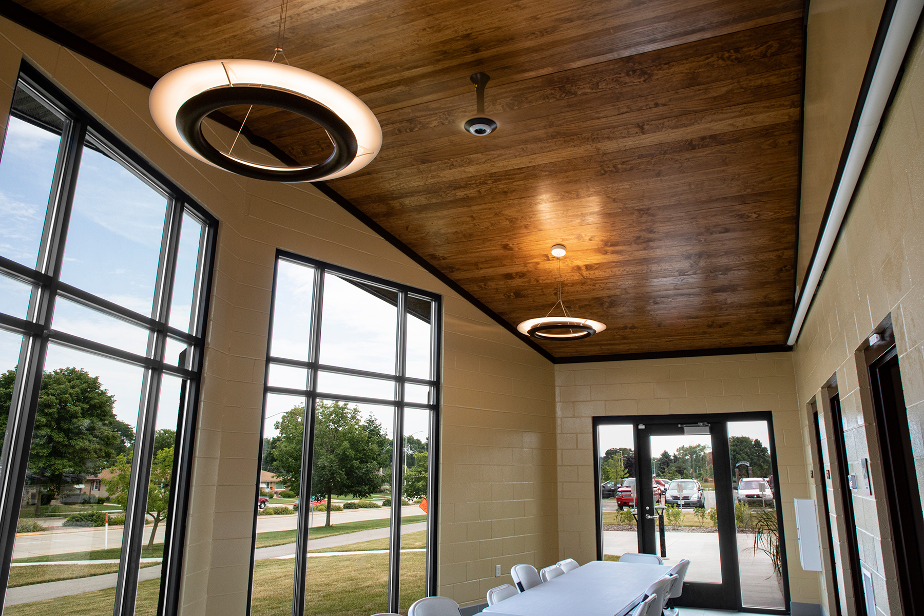 Cosmo ring pendants in a small conference room with big windows