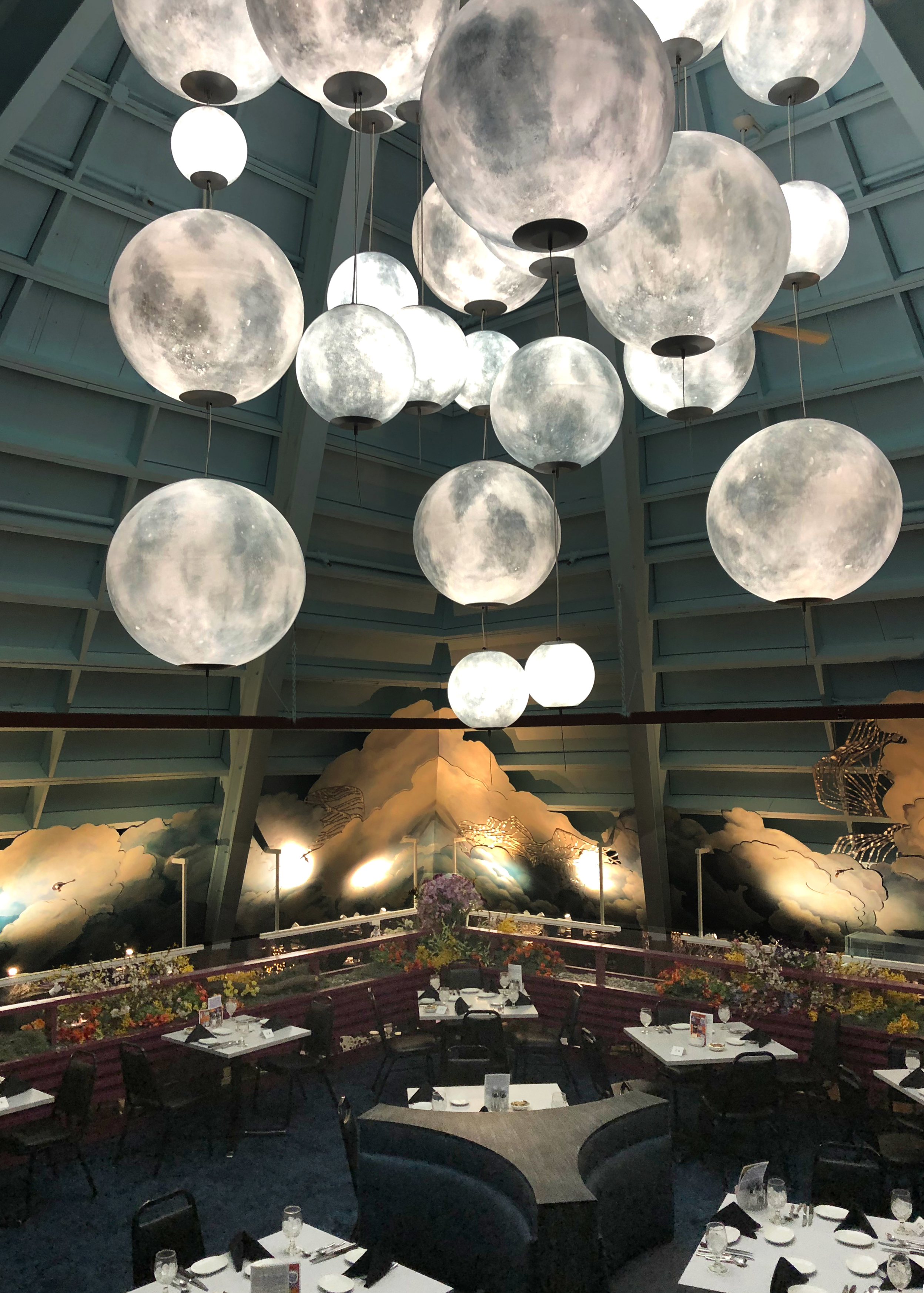 Custom moon-like globe pendants at the Fireside Theater, overlooking the dining area