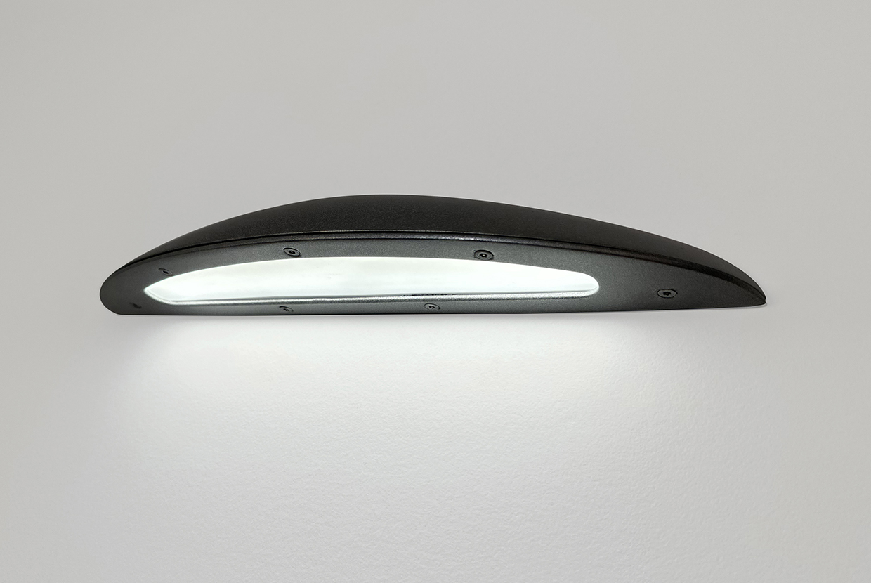 A downlight wall sconce with a smooth, curved body