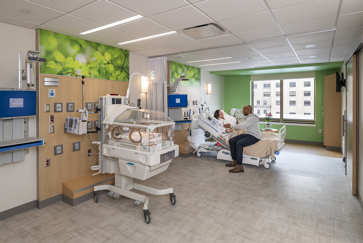 Parents in NICU room holding preemie