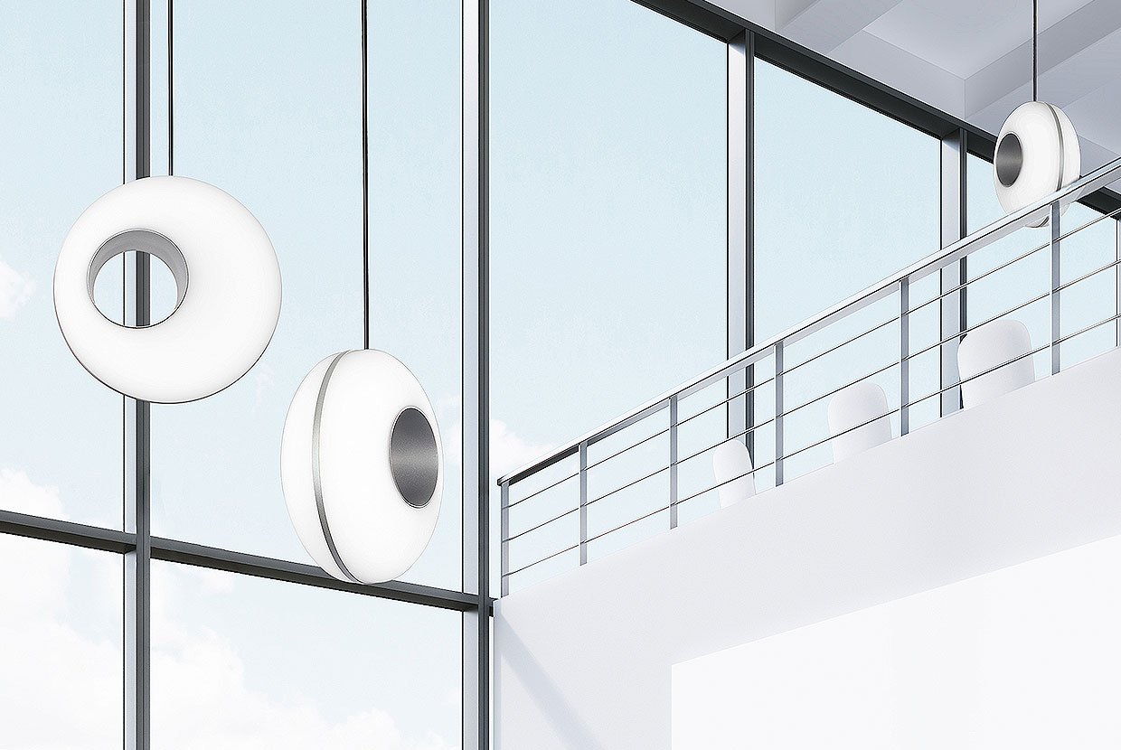 Peek pendants as modern office lighting fixtures above a clean, minimal conference room. 