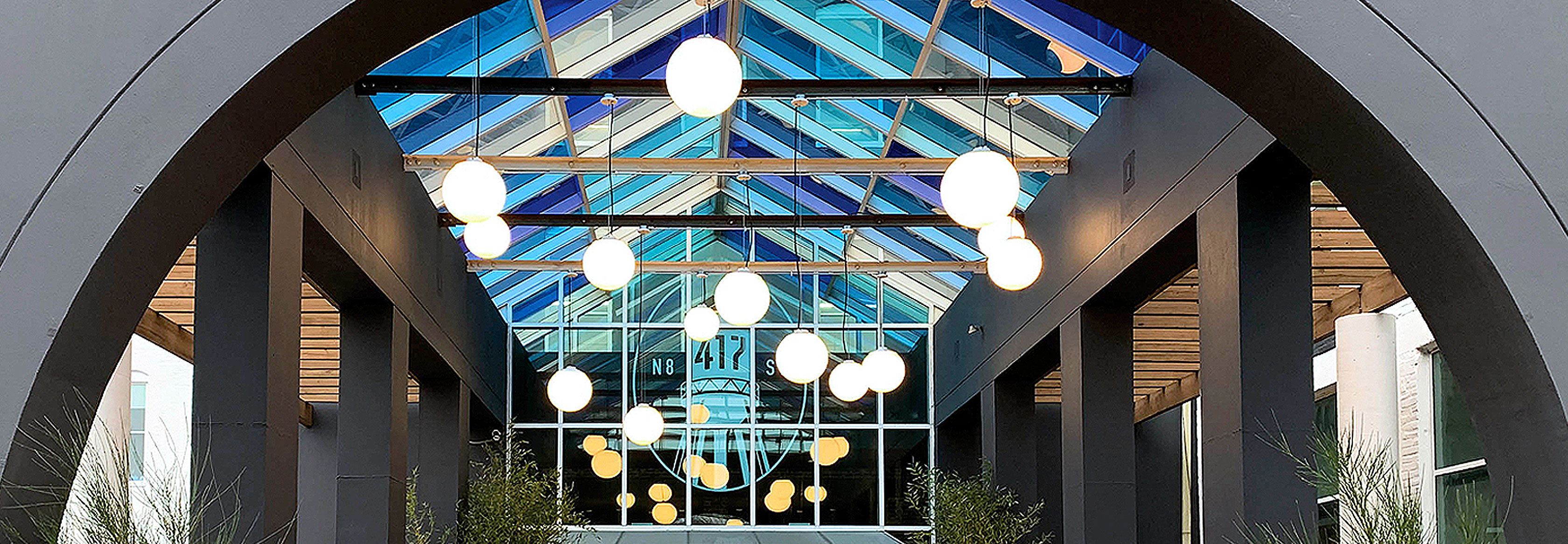 Zume Out globe pendant lights mounted in atrium entryway